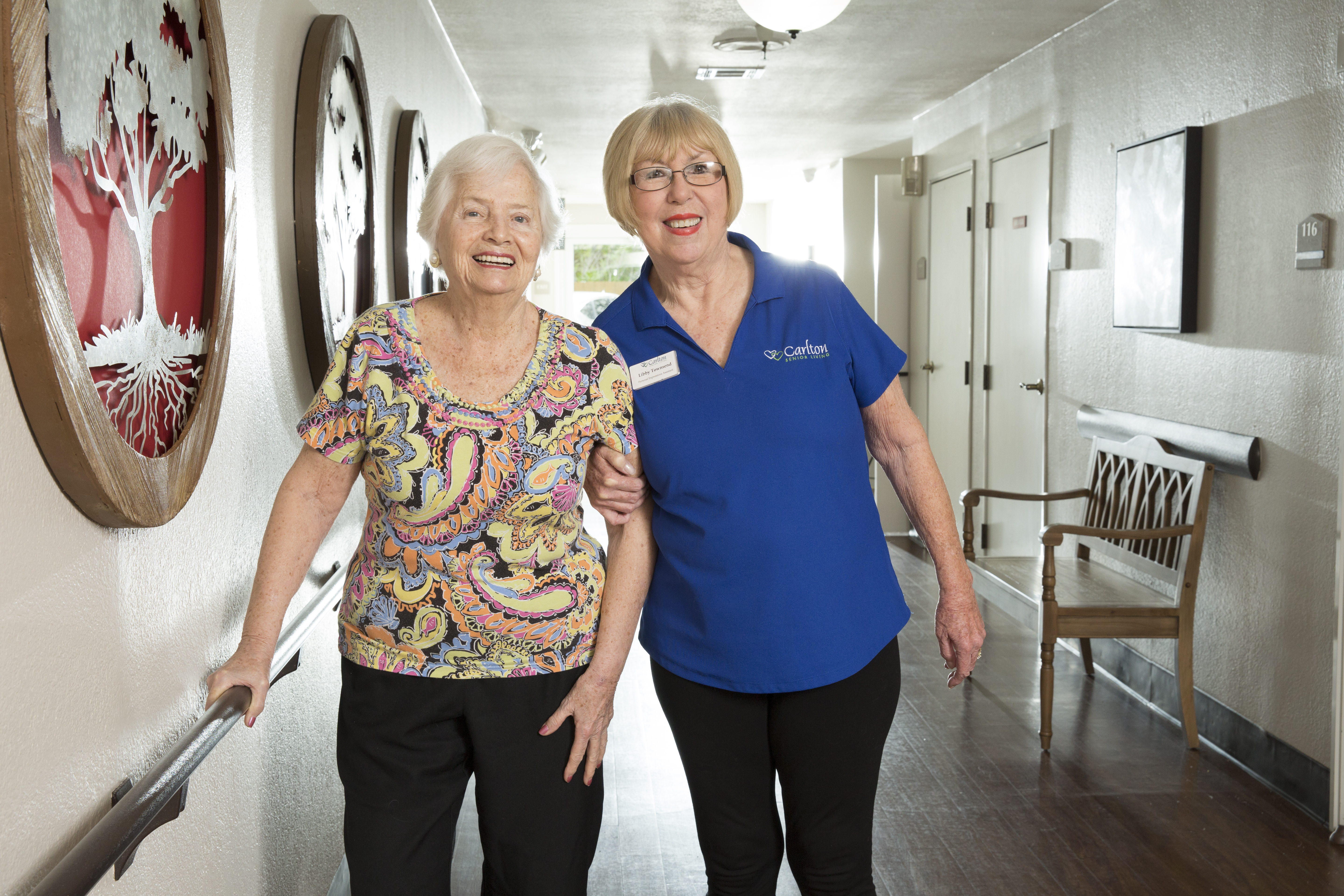Care professional supporting a senior in a care setting